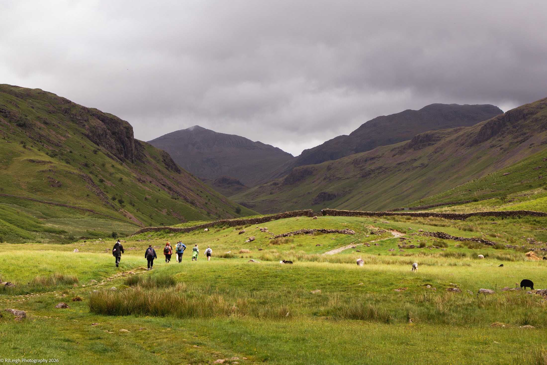 A retreat group walking together through a Lake District valley